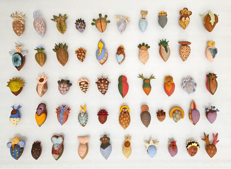Elodie Alexandre | The Singing Hearts | 2023 | Red earthenware clay, slips and underglazes (51 individual units) | 5 x 3 Inches each approx.